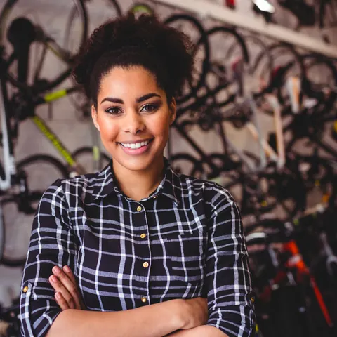 Une loueuse de vélos souriante dans sa boutique